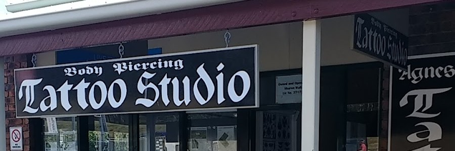The black and white Body Piercing Tattoo Studio sign over the old Agnes Water studio